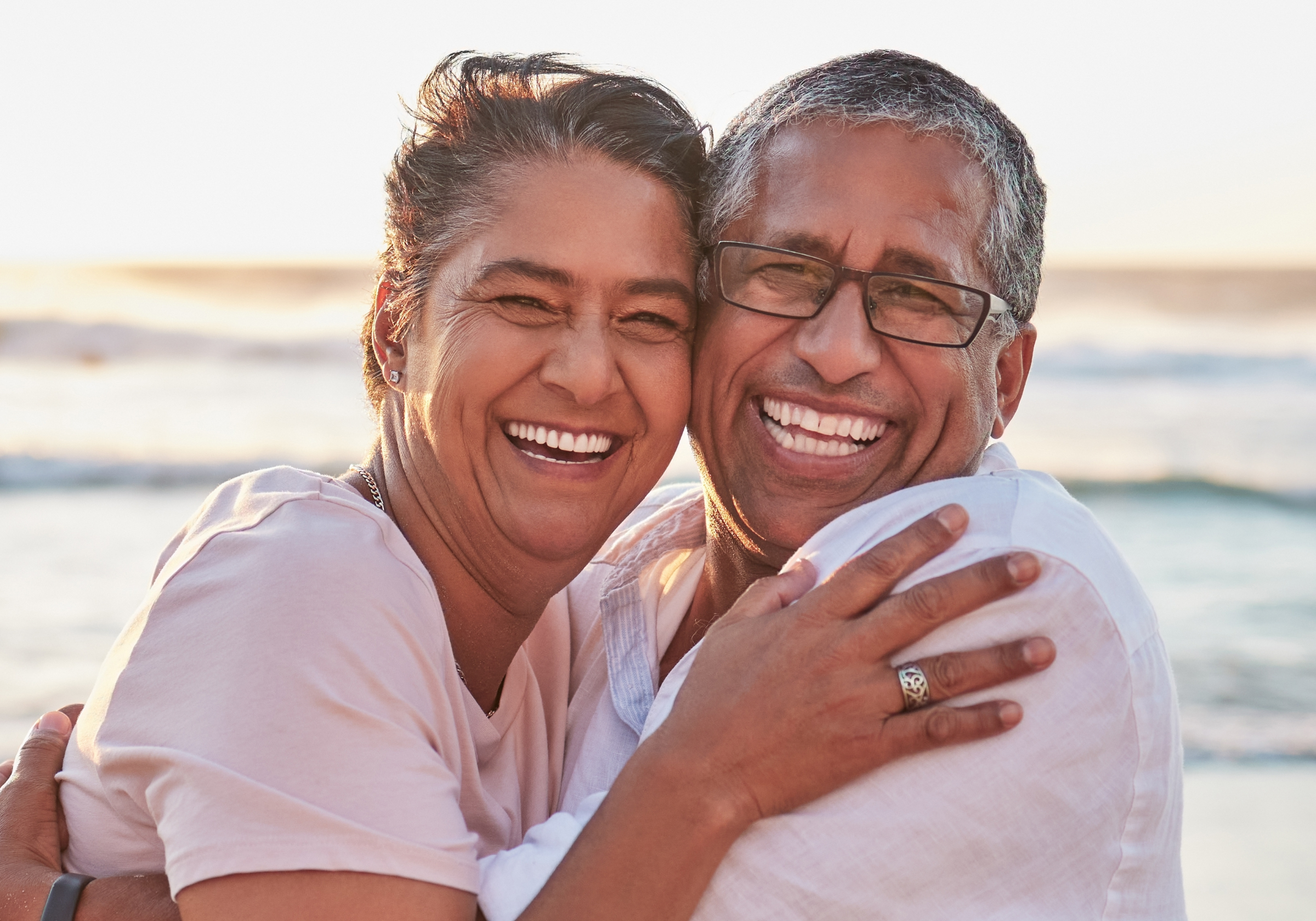 couple, beach travel and hug by water of Dubai