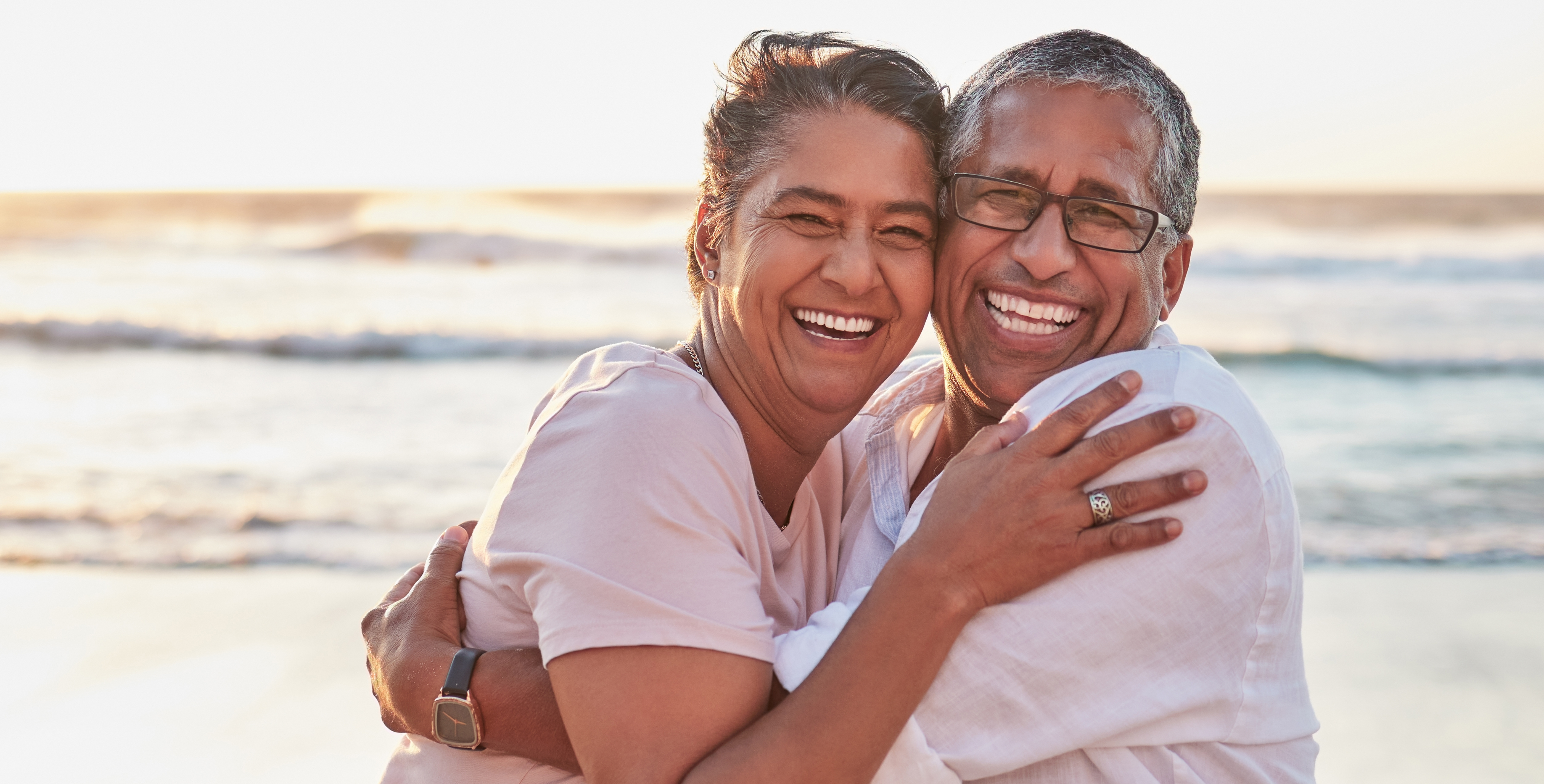 couple, beach travel and hug by water of Dubai